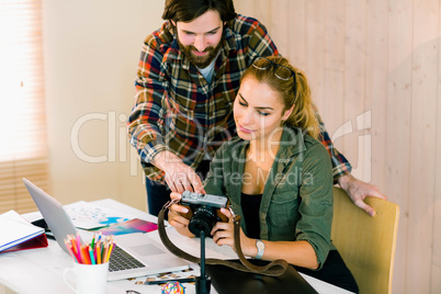 Creative team working at desk with laptop