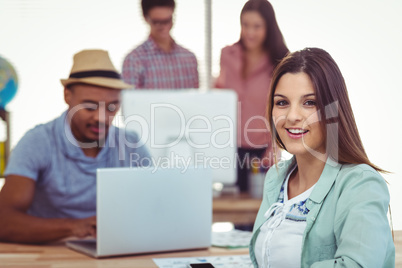 Young creative workers smiling at camera