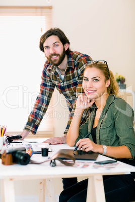 Creative team working at desk with laptop