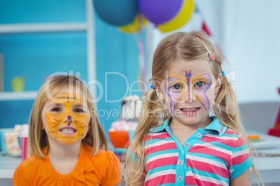 Smiling girls with their faces painted