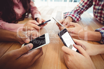 Young creative team using phones