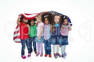 Girls standing with american flag overhead