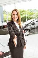 Smiling saleswoman ready to shake hand