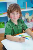 Young boy drawing on paper