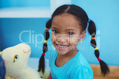 Small girl holding a pony teddy
