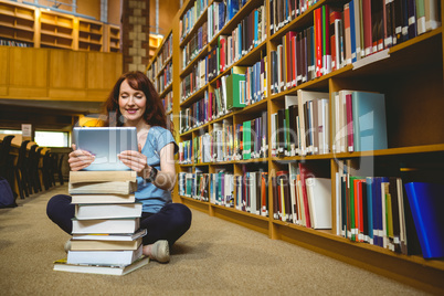 Mature student in library using tablet