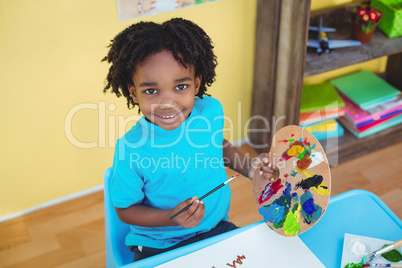 Smiling child creating a picture