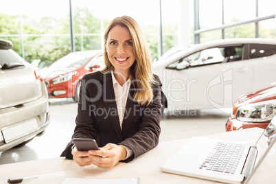 Smiling saleswoman having a phone call