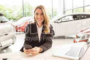 Smiling saleswoman having a phone call