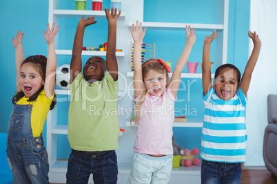Happy kids with arms raised together