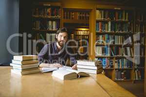 Hipster student studying in library