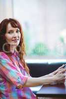 Mature student using tablet in cafe
