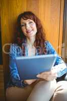 Mature student using tablet in cafe