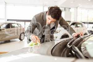 Focused businessman looking at the car body