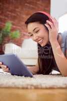 Asian woman using tablet on floor