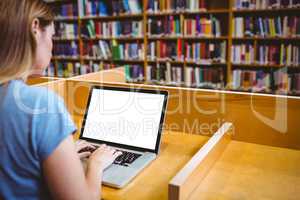 Mature student in the library using laptop