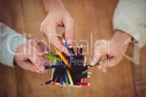Creative team choosing different coloured pencils