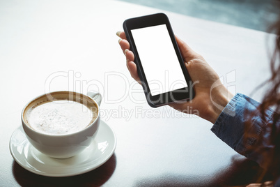 Woman taking a photo of her coffee