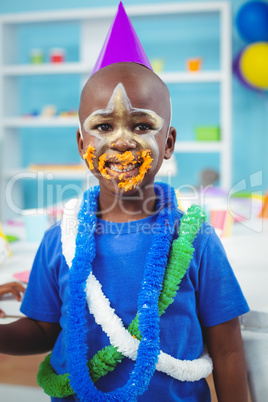 Smiling kid with icing on his face