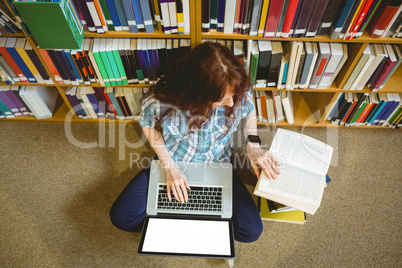 Mature student in library using tablet