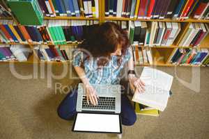 Mature student in library using tablet