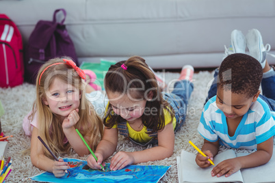 Smiling kids drawing pictures on paper