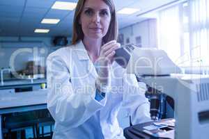 Scientist working with a microscope in laboratory