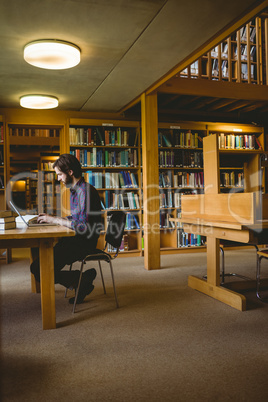 Hipster student studying in library