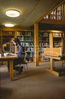 Hipster student studying in library