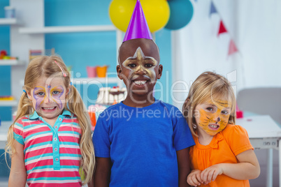 Smiling kids with faces painted