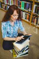 Mature student in library using tablet