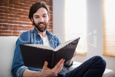 Casual man reading on his sofa Casual man reading on his sofa