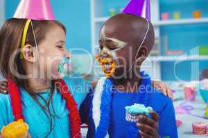 Smiling kids with icing on their faces