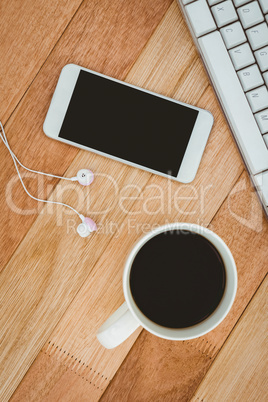 Black smartphone with cup of coffee