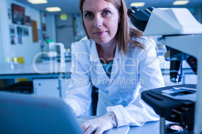 Scientist working with a laptop in laboratory