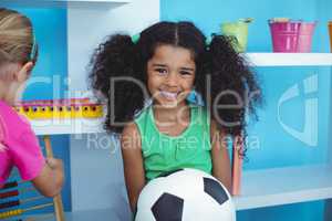 Small girl holding a soccer ball