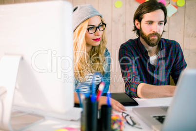 Creative team working at desk with laptop