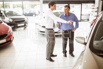 Salesman showing somethings to a man