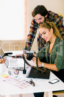 Creative team working at desk with laptop