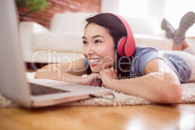 Asian woman using laptop on floor