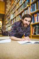 Student studying on floor in the library