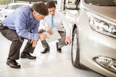 Salesman showing somethings to a man