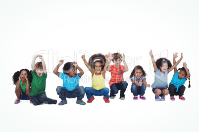 A row of children crouching down together