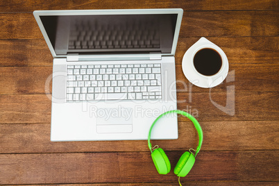 View of a grey laptop with a green headphone