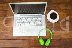 View of a grey laptop with a green headphone