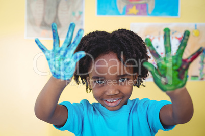 Smiling kid holding up his hands