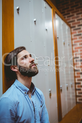 Hipster student feeling sad in hallway