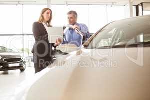 Smiling businesswoman undersign a car contract