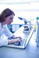 Scientist working with a laptop in laboratory