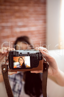 Asian woman on the couch taking selfie